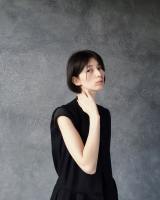 woman-in-black-top-standing-near-gray-wall-1030915