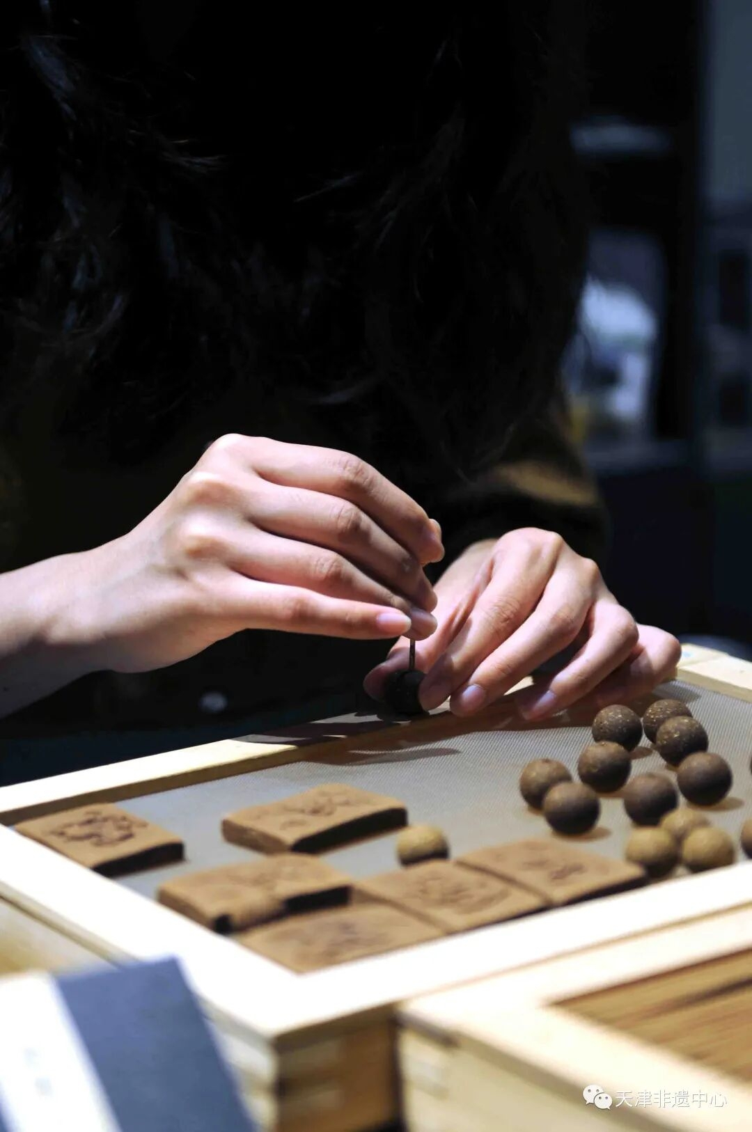 Artisan hand-rolling incense beads through 36 meticulous steps - Heritage craftsmanship