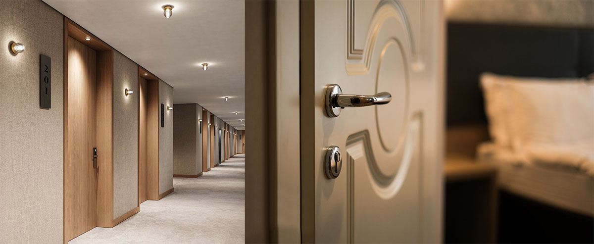 Custom-designed room doors installed along a hotel corridor. 