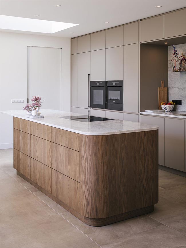 Modern kitchen with natural wood veneer island and beige lacquered cabinets