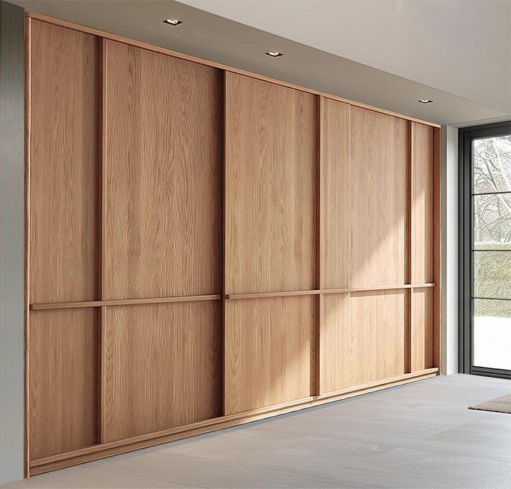 Built-in sliding door closet in solid oak wood