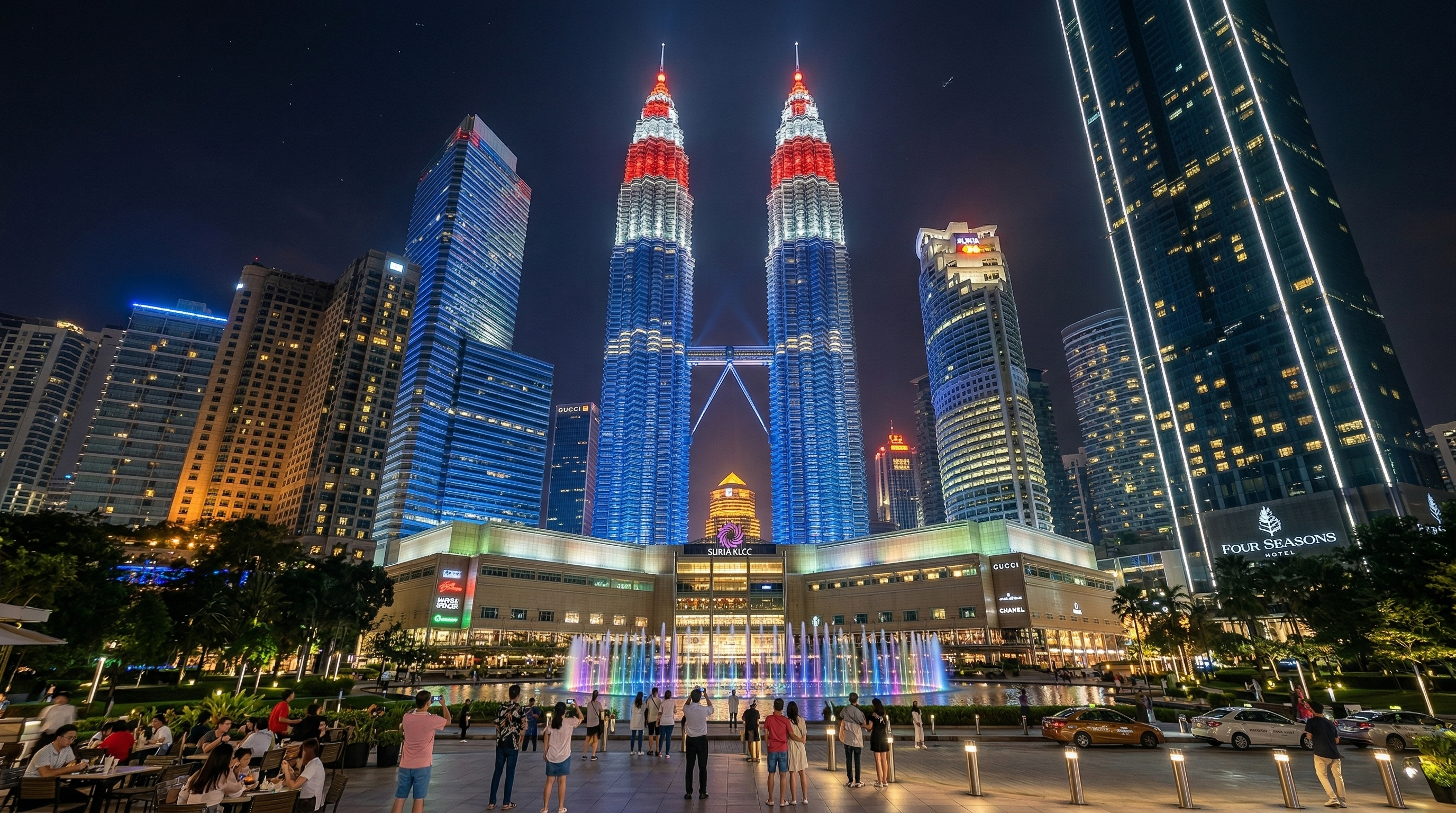 Urban night illumination transforming Suria KLCC into a glowing landmark