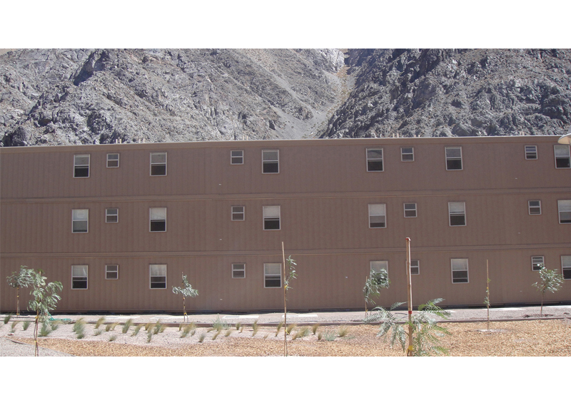  Modular container housing used for mining camps employs reinforced cables and tie-down components, ensuring stability under strong wind conditions.