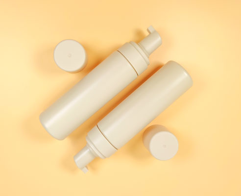 Set of 2 HDPE foam pump bottles (200ml) with cylindrical shape and aligned pumps, all in matte beige finish. Suitable for foaming face wash, tanning mousse, or personal care products.