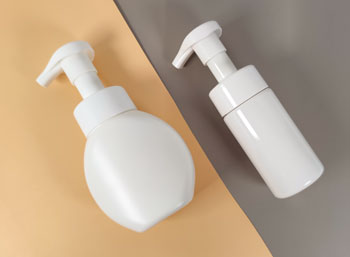 A HDPE foam bottle with mild gloss and a glossy PET foam bottle