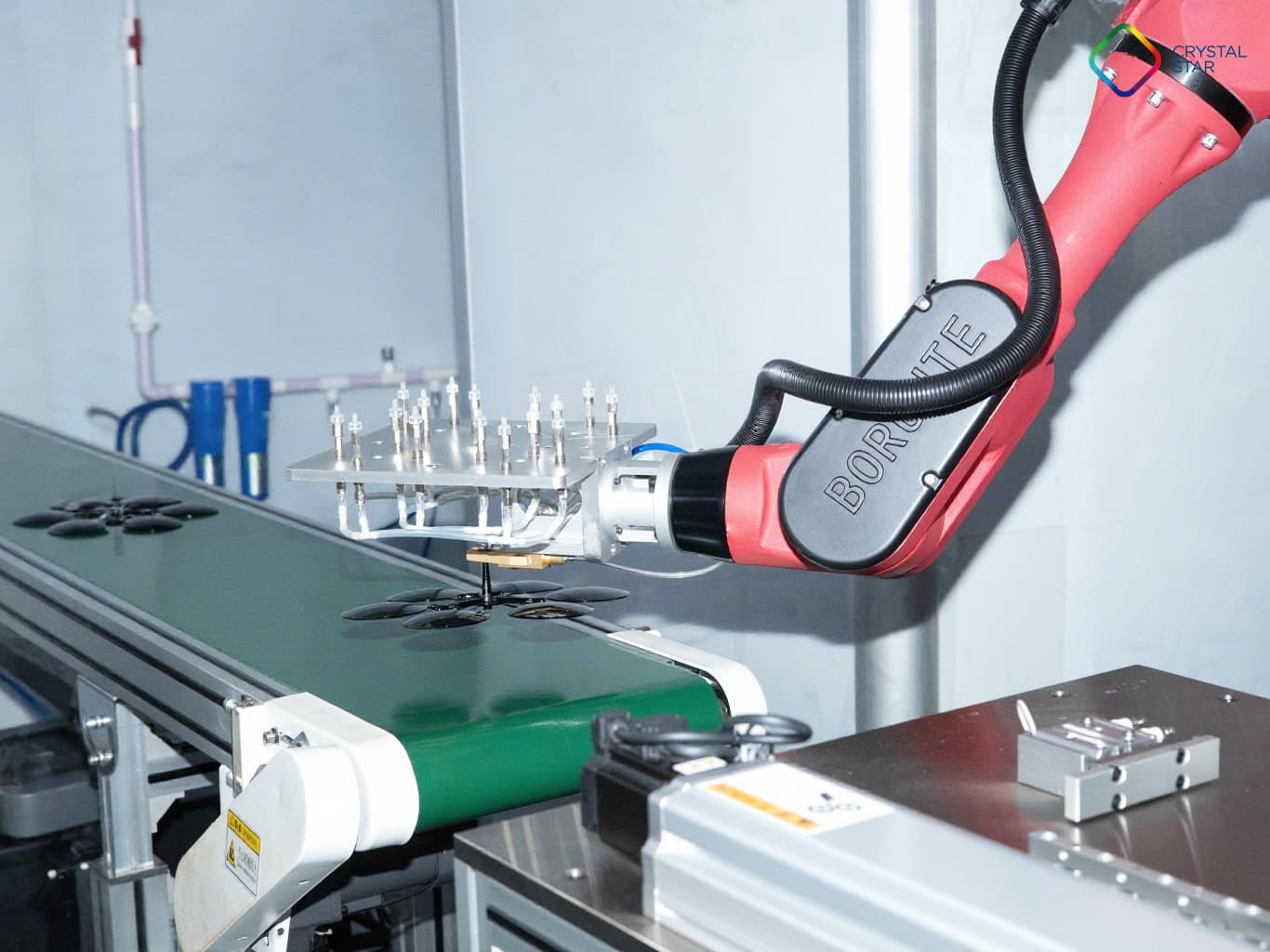 Automated robotic arm handling sun lenses to ensure precision manufacturing standards.